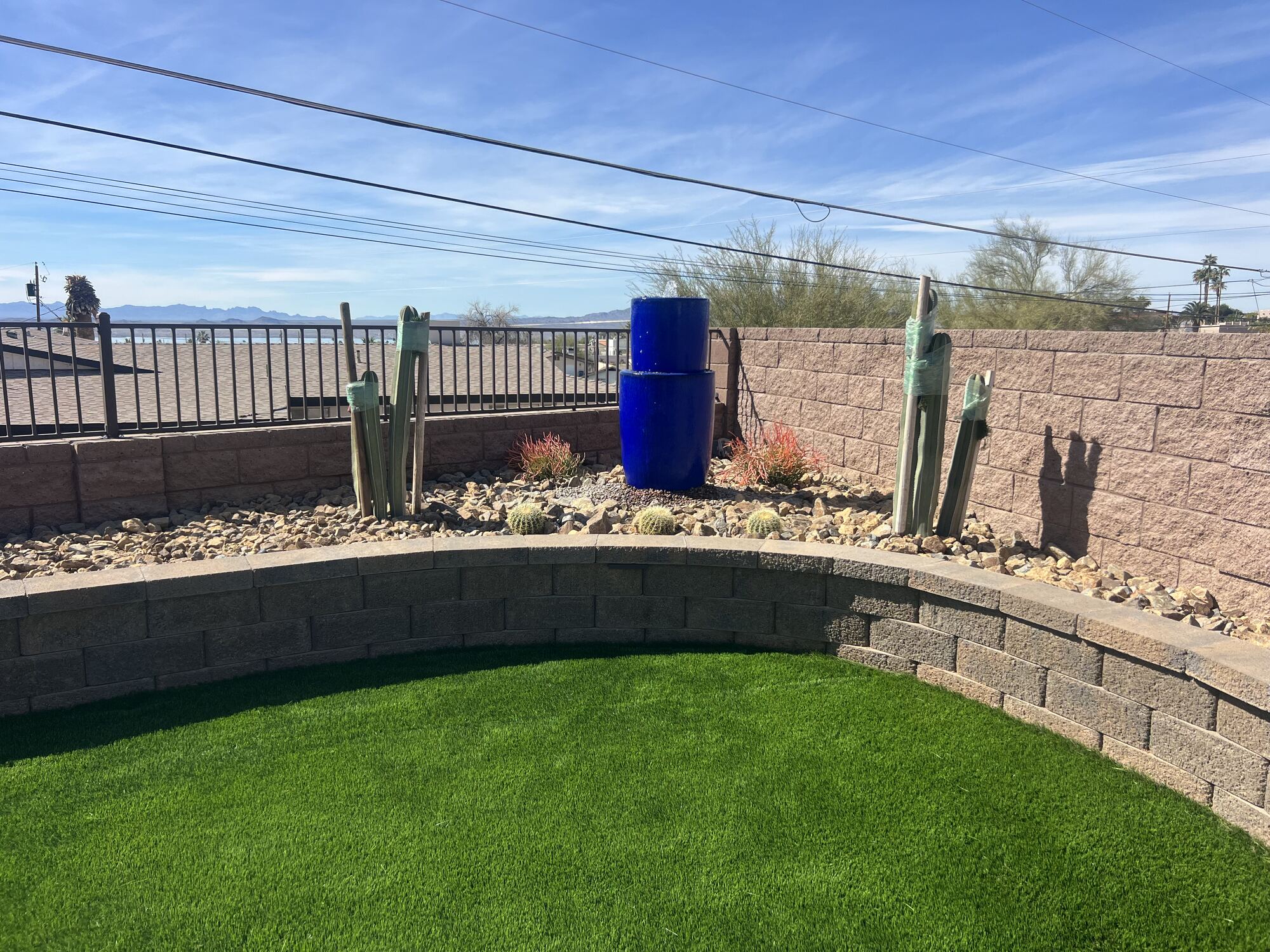 Retaining Walls project by Havasu Pavers in Lake Havasu City — Curved block retaining wall with turf and desert planting
