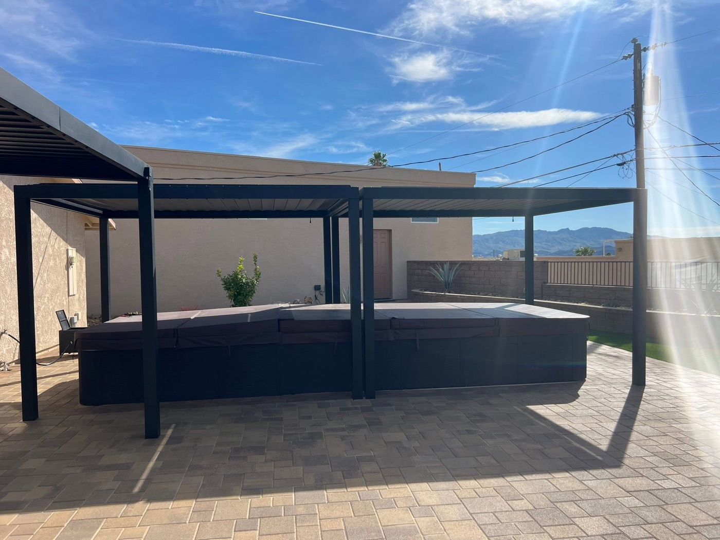 Backyard Discovery steel pergola over a paver patio and spa by Havasu Pavers in Lake Havasu City